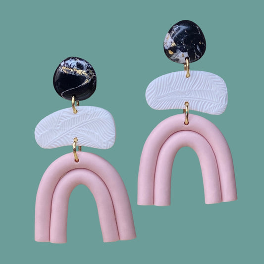 Modern polymer Clay statement earrings in pale pink rainbow shape with black and white marble accents.